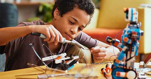 Young middle school student taking part in a STEM activity. 